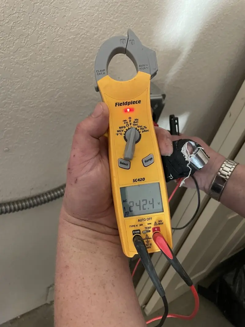 Voltage testing with clamp meter during Outlet Installation in Alexander
